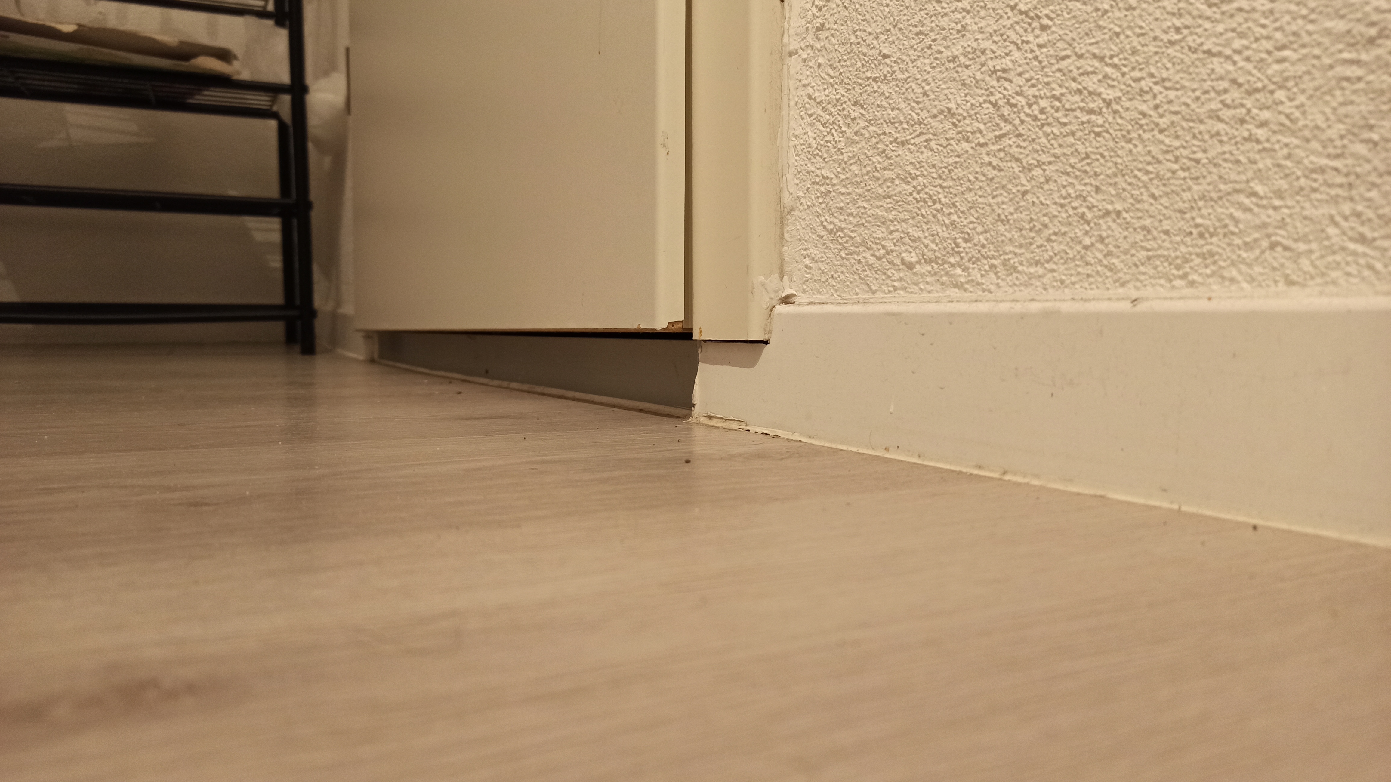 Gap under an interior door at floor level — the return-air path that keeps room pressure balanced when the AC runs